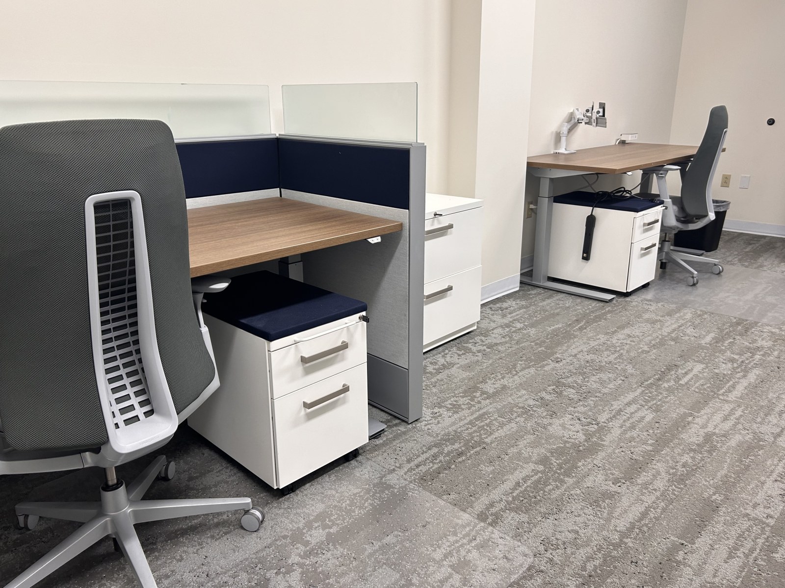 Close view of a team room workstation with a rolling pedestal and lateral file cabinet