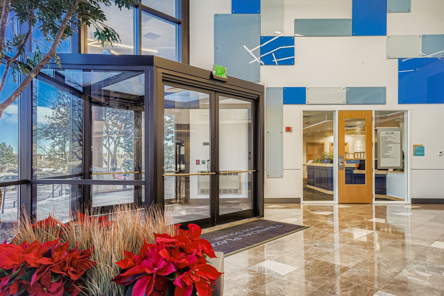 Modern flexible office workspace with glass entrance at Intelligent Office location.