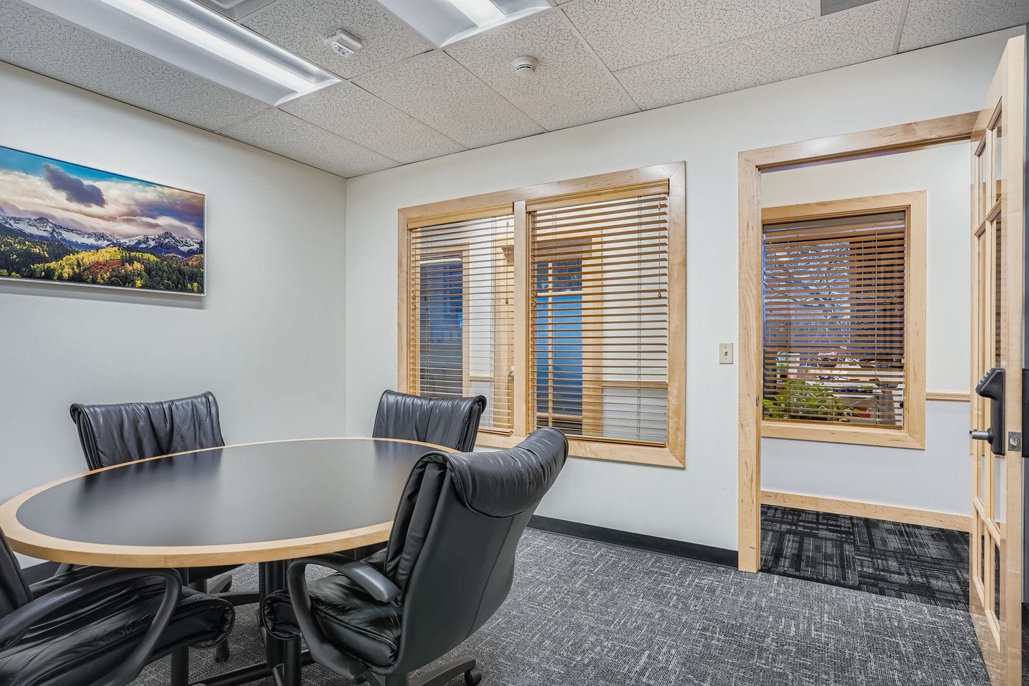 Modern office conference room with leather chairs and wooden accents at Intelligent Office.