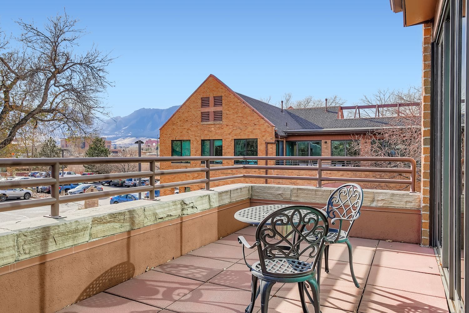 Balcony view of an office building with mountain scenery in the background, ideal for remote work and relaxation.