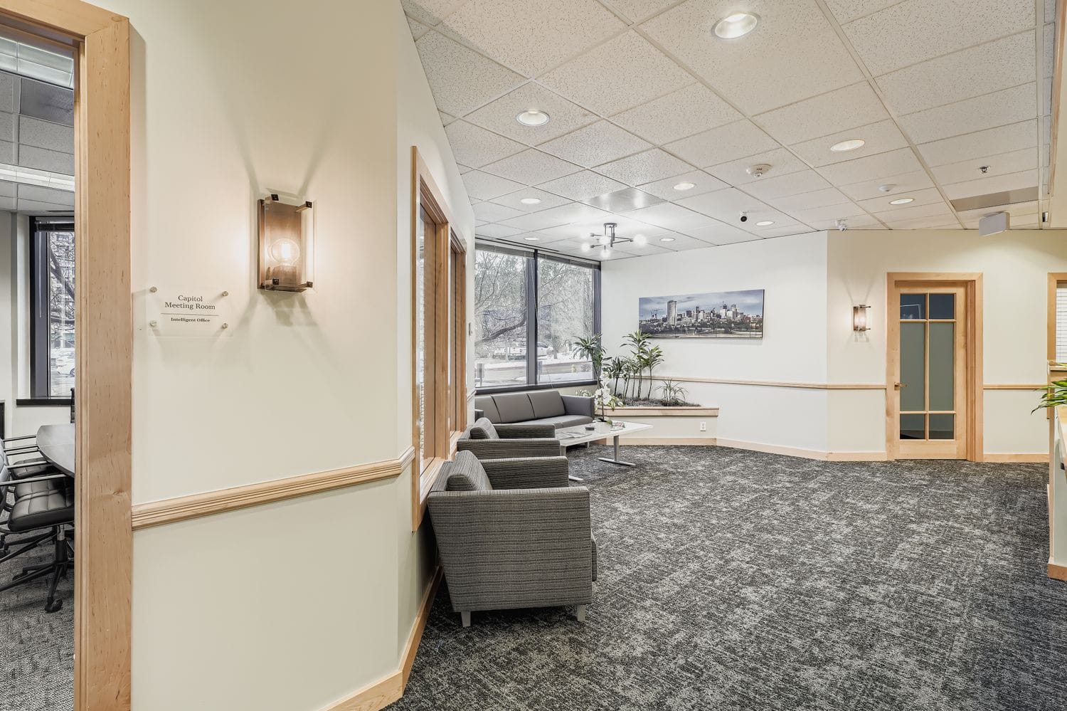 Comfortable office waiting area at Intelligent Office with natural light and modern decor.