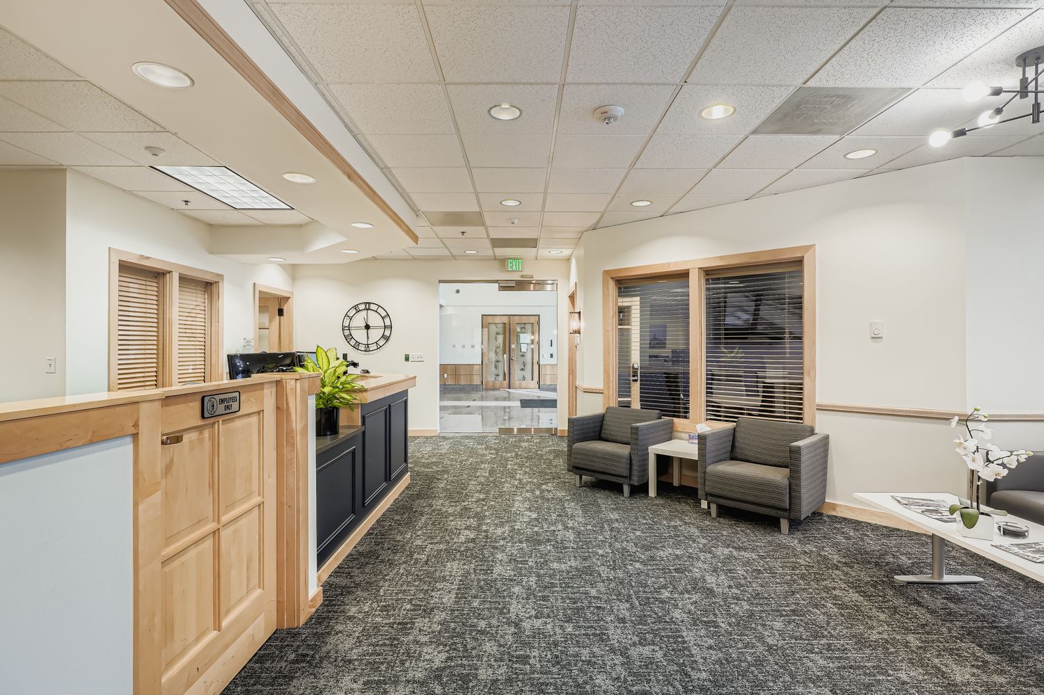 Modern office reception area with comfortable seating and professional branding for Intelligent Office services.