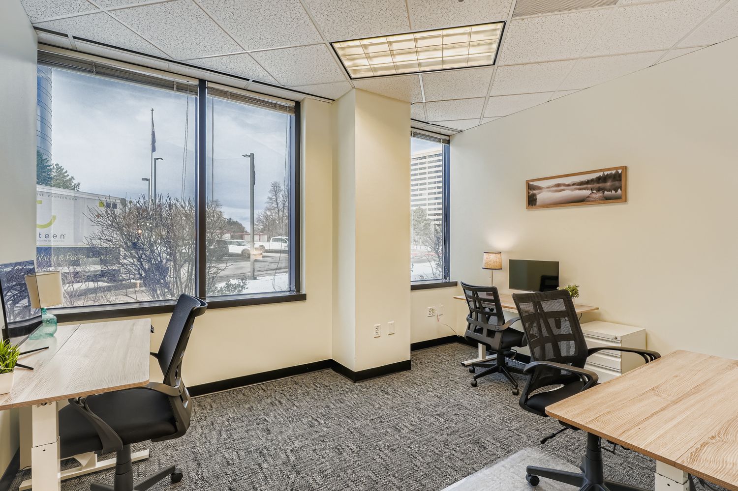 Modern coworking office space with large windows and ergonomic chairs for productivity.