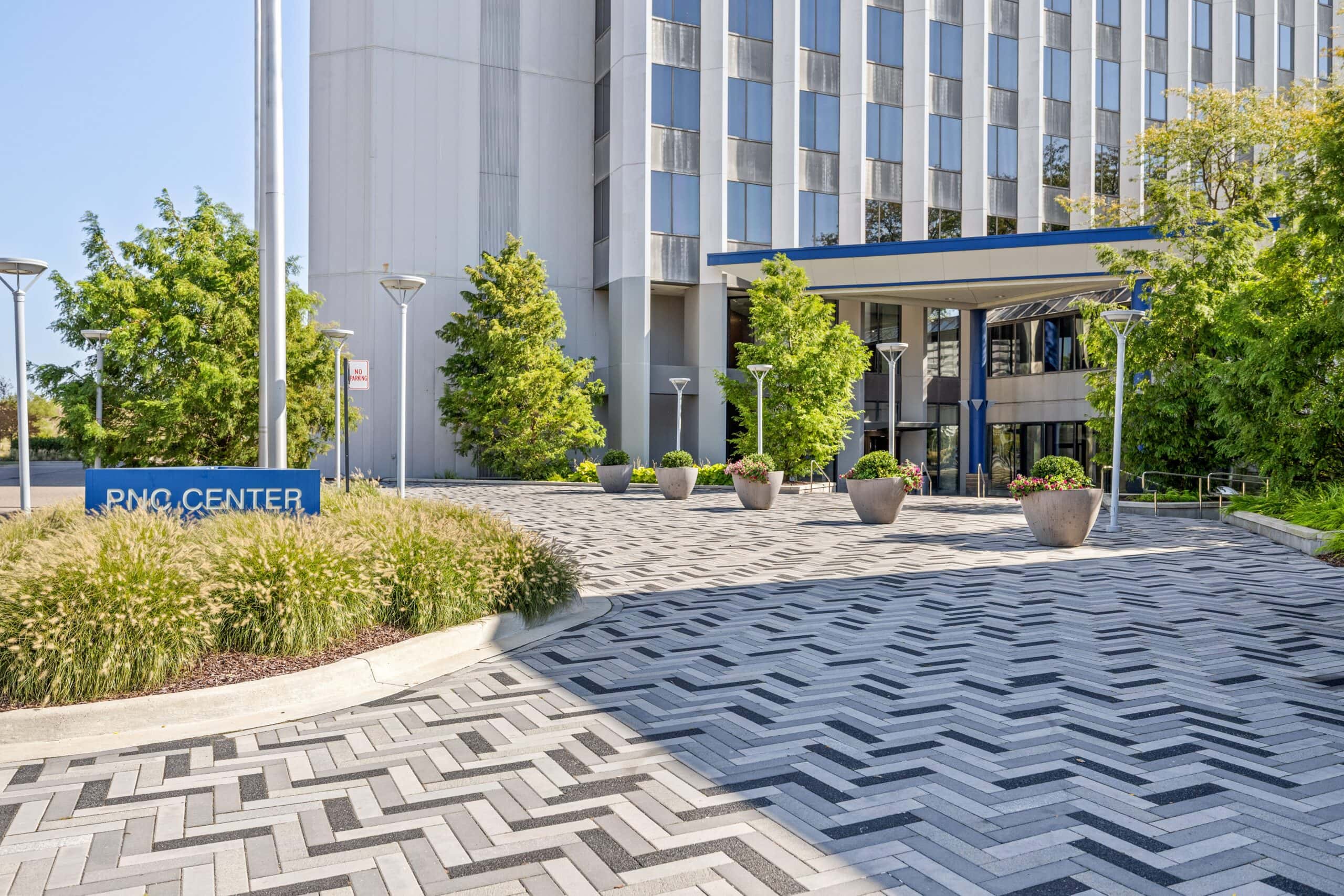Modern office building entrance at Troy with landscaped surroundings and PNC Center signage.