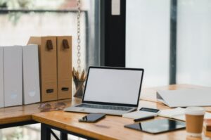 Modern office workspace with laptop, files, and office supplies for flexible business solutions.