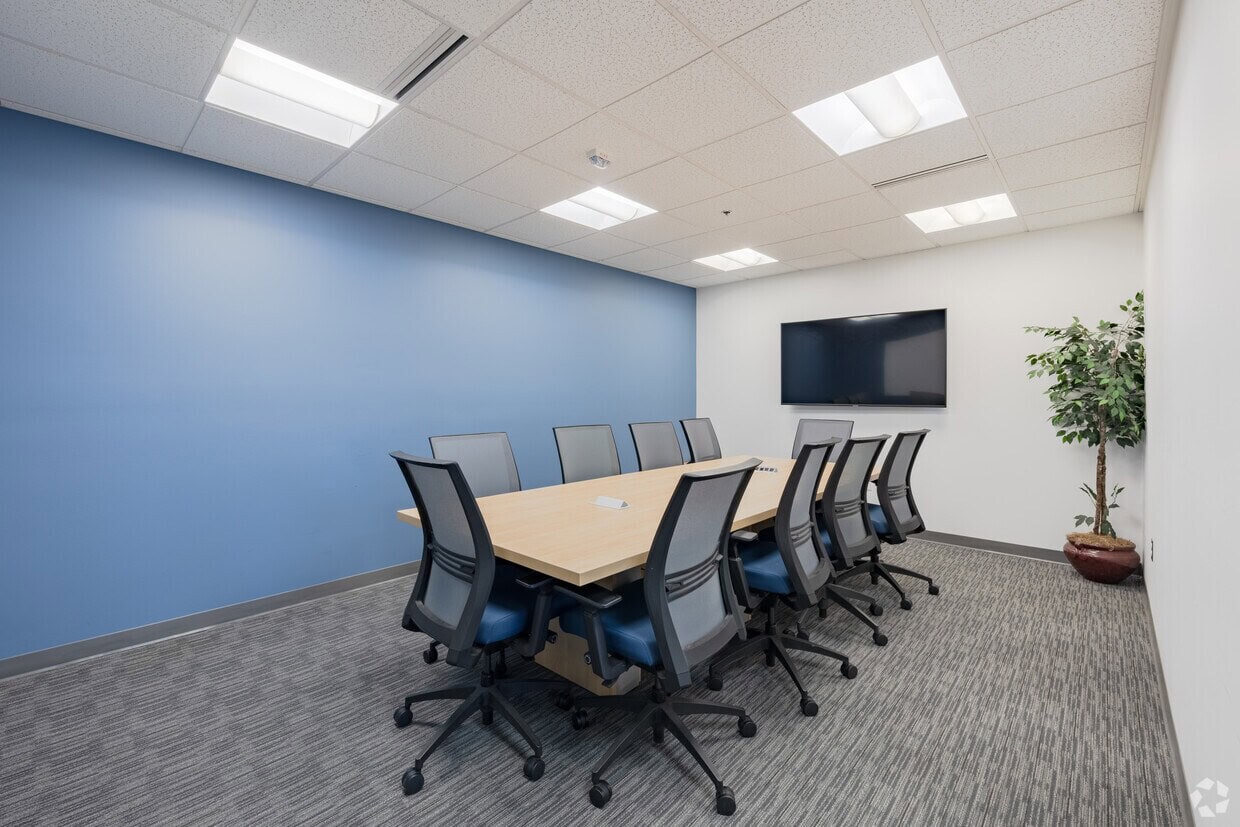 Modern conference room with corporate meeting setup and presentation technology.