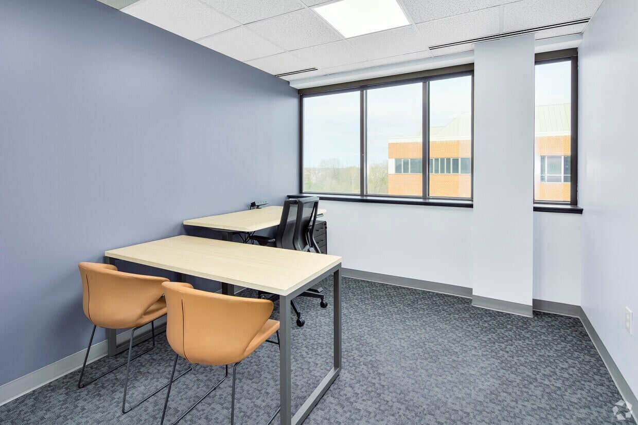 Modern office meeting room with large windows, natural light, and contemporary furniture for profess.