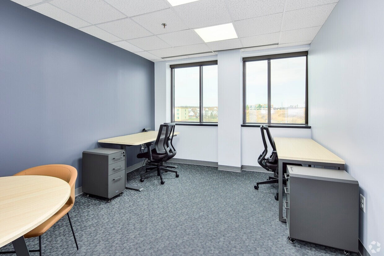 Office workspace with desks and chairs at Intelligent Office.