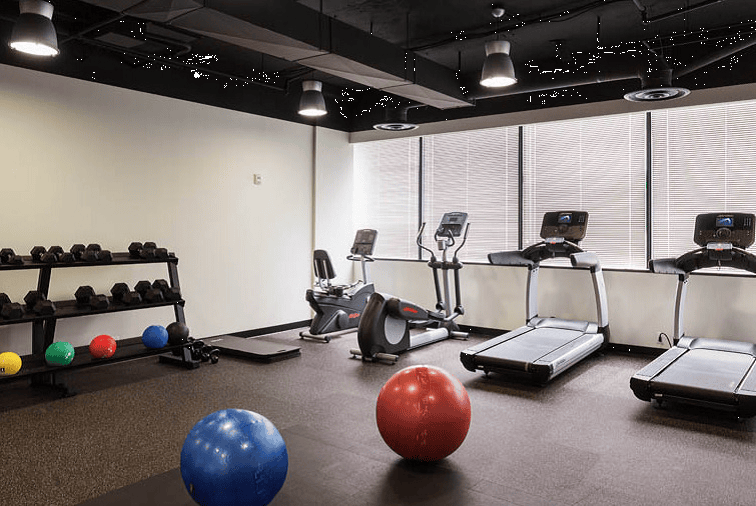 Fitness room with treadmills, exercise balls, and gym equipment at Intelligent Office.