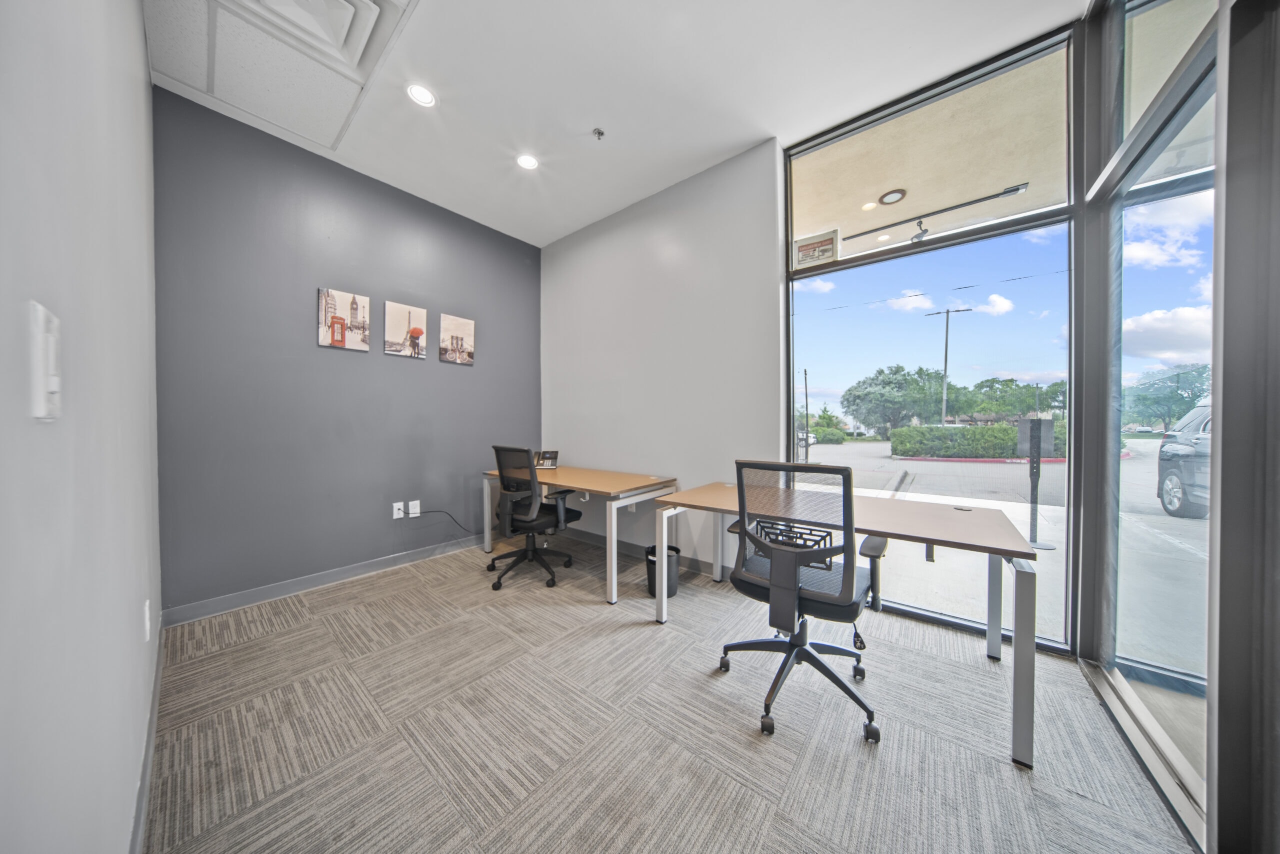 Office space with large windows, natural light, and contemporary furniture.