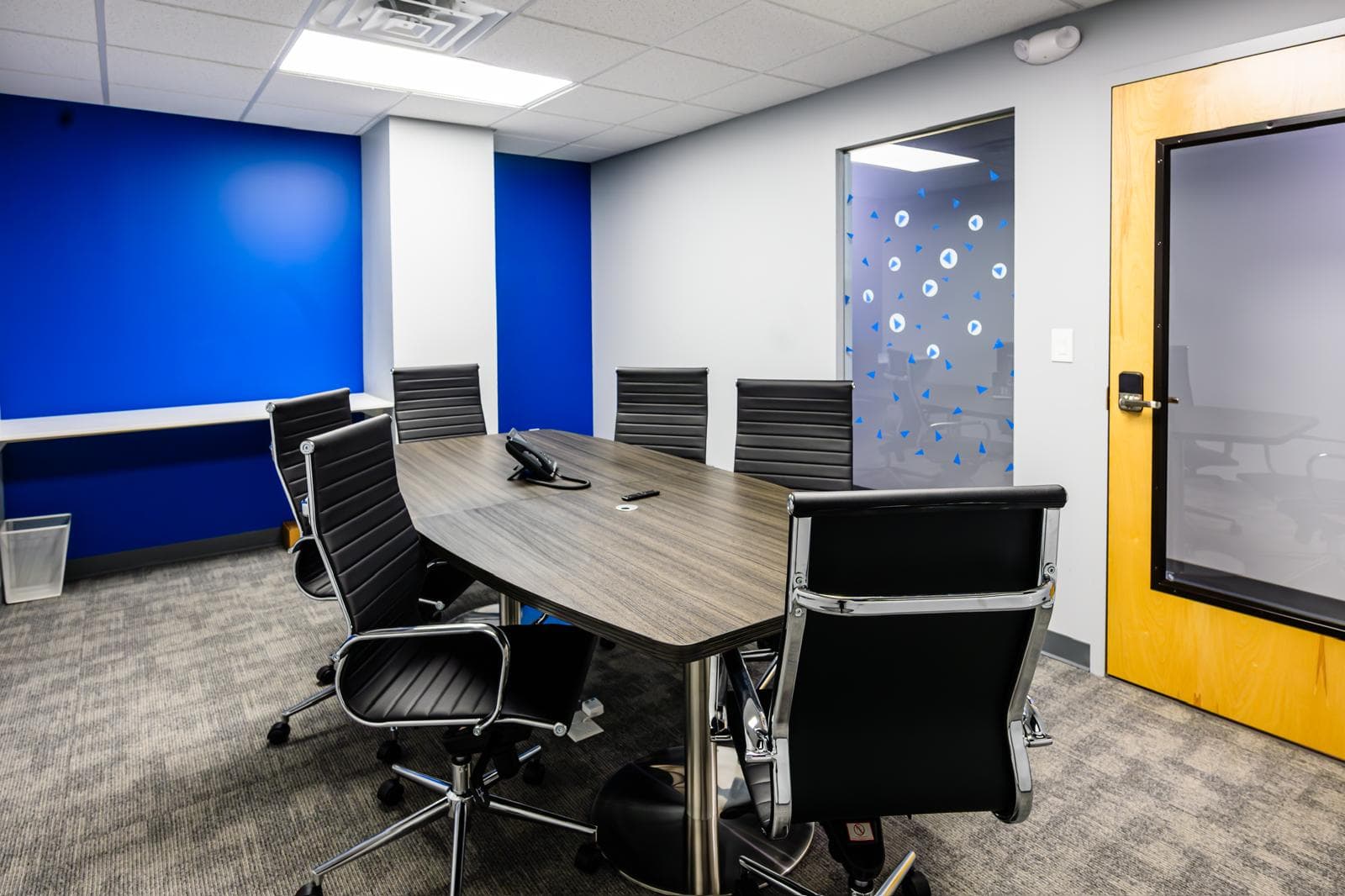Professional conference room with modern furniture and technology setup.